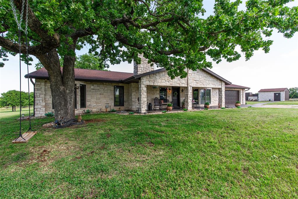 2043 Huddleston Road Sunset, TX 76270 - Photo 1 of 36 a front view of a house with a yard