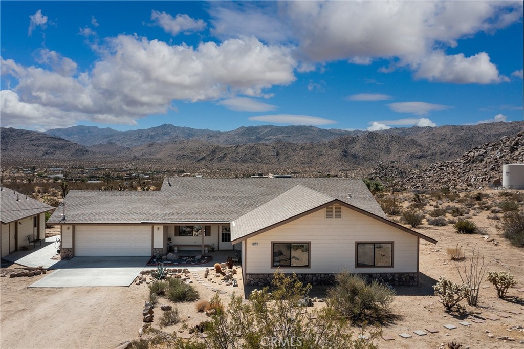 63257 Wagon Wheel Road Joshua Tree, CA 92252 - Photo 1 of 1 a view of a house with a yard