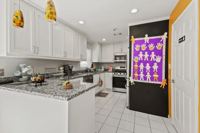 a kitchen with stainless steel appliances granite countertop a refrigerator sink and cabinets