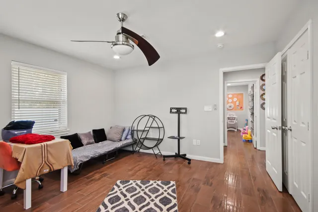 a living room with furniture and wooden floor