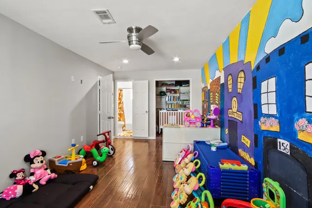 a play room with toys and a book shelf