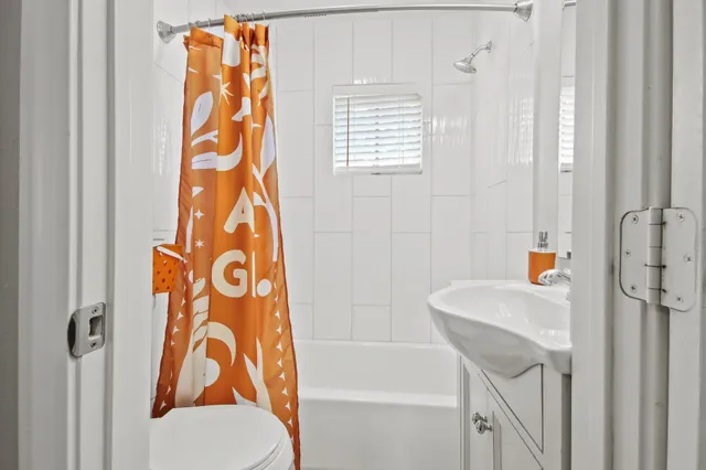 a bathroom with a shower curtain and a sink