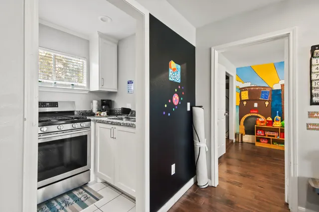 a kitchen with stainless steel appliances granite countertop a refrigerator and a stove top oven