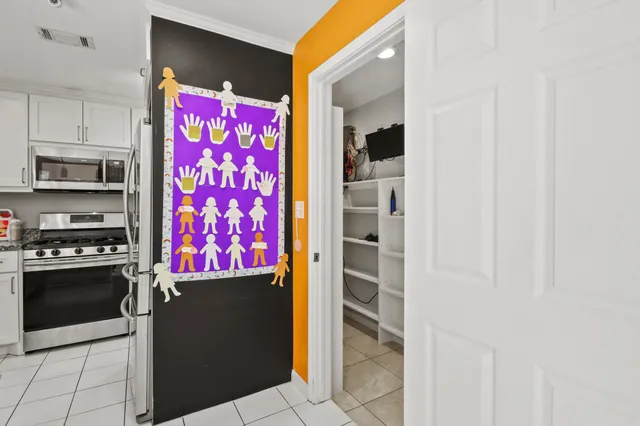 a kitchen with stainless steel appliances a refrigerator and a stove top oven