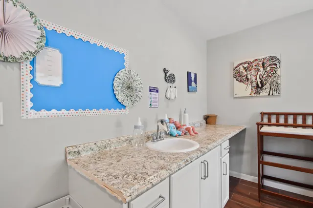 a bathroom with a granite countertop sink and a mirror