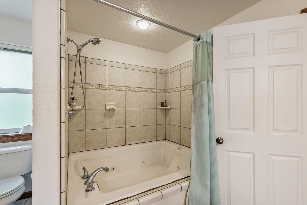 167 Rippling Way Merlin, OR 97532 - Photo 27 of 39 a bathroom with a bathtub and a shower