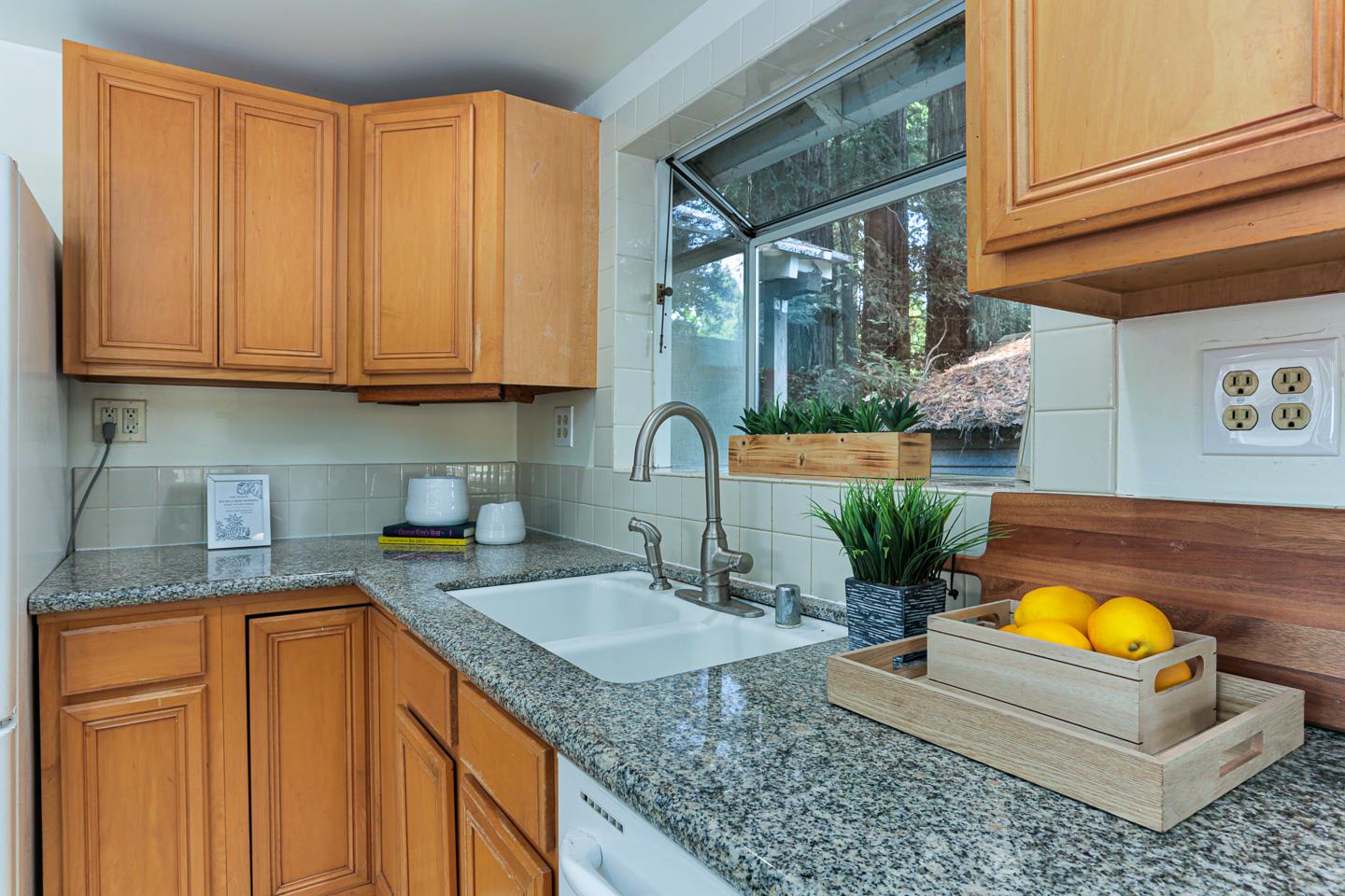 136 Pool Drive Boulder Creek, CA 95006 - Photo 13 of 25 a kitchen with stainless steel appliances granite countertop a sink a stove and a wooden cabinets