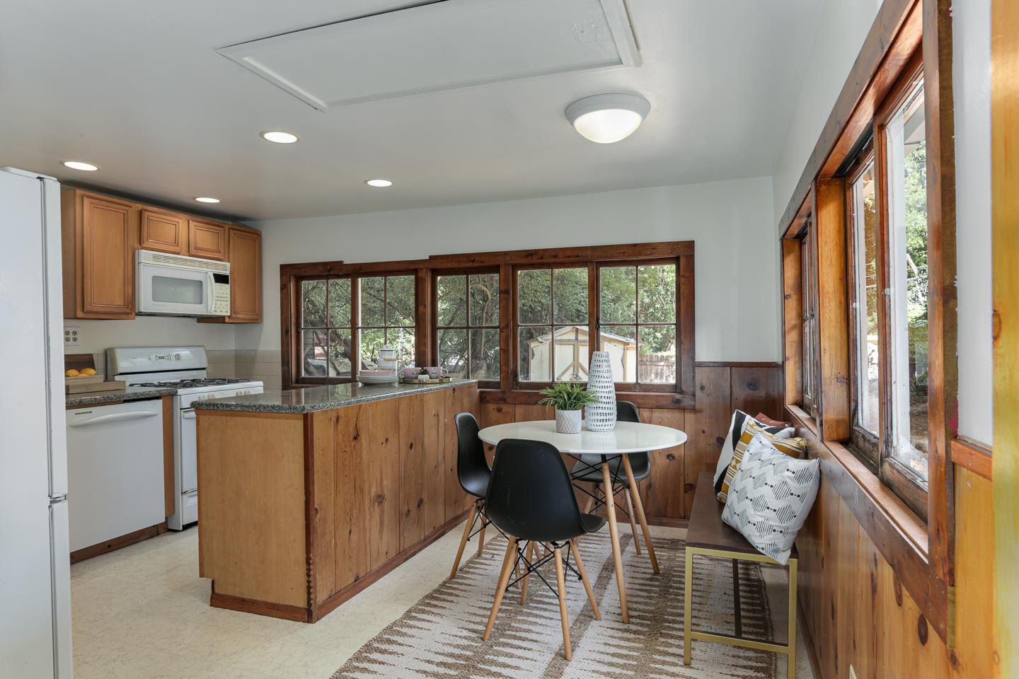 136 Pool Drive Boulder Creek, CA 95006 - Photo 5 of 25 a kitchen with stainless steel appliances granite countertop a stove top oven a sink dishwasher and a dining table with wooden floor