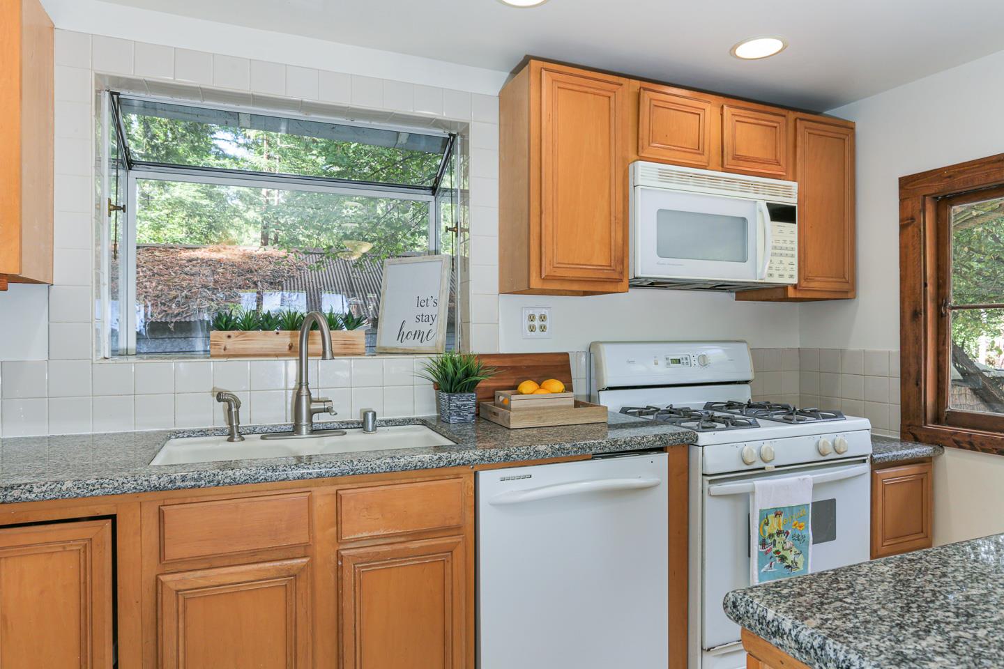 136 Pool Drive Boulder Creek, CA 95006 - Photo 6 of 25 a kitchen with granite countertop cabinets stainless steel appliances a sink and a window