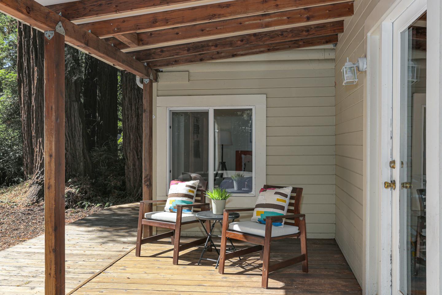136 Pool Drive Boulder Creek, CA 95006 - Photo 10 of 25 a view of a dinning table and chairs in porch with wooden floor
