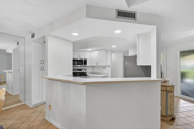 a dining room with furniture a chandelier and wooden floor