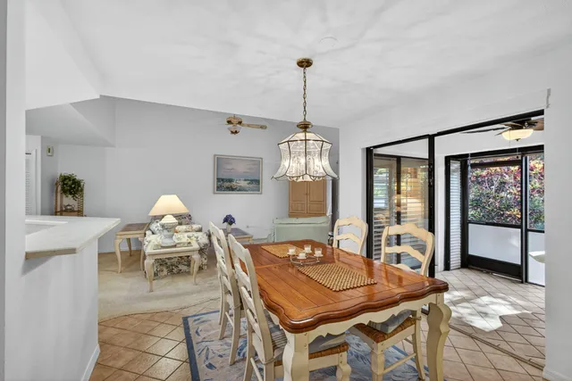 a dining room with furniture a chandelier and window