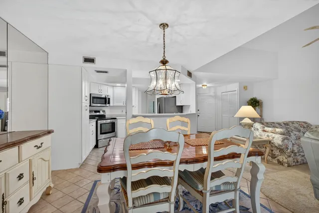 a living room with lots of furniture and a chandelier