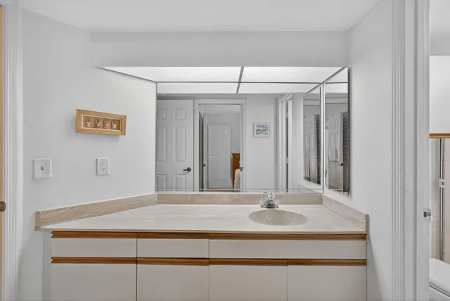 a bathroom with a sink double vanity and a mirror