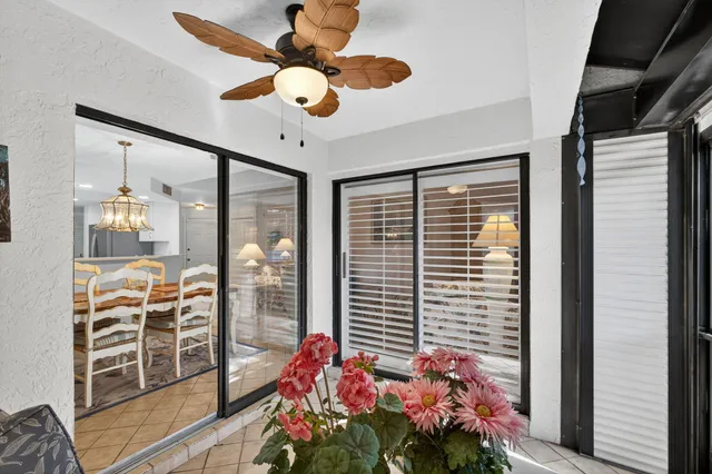 a view of backyard with outdoor seating and a potted plant