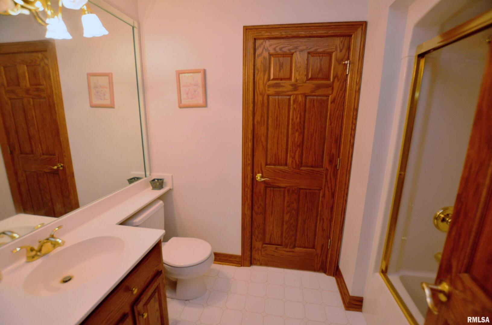 3 Chestnut Drive Blue Grass, IA 52726 - Photo 8 of 15 a bathroom with a sink a toilet and shower