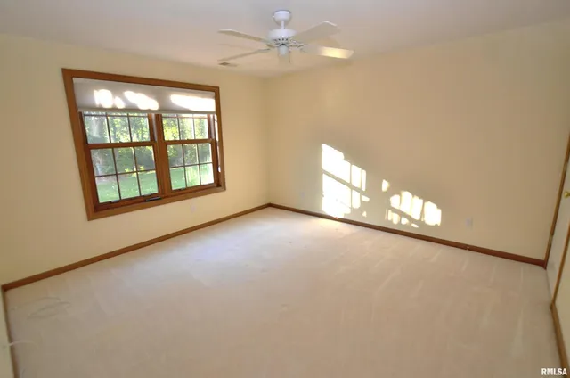 an empty room with windows and entrance