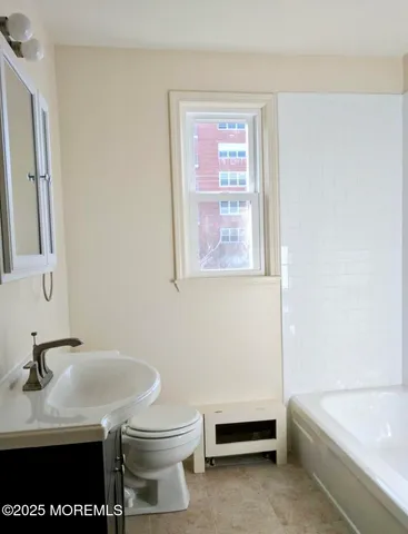 a bathroom with a sink a toilet and a bathtub