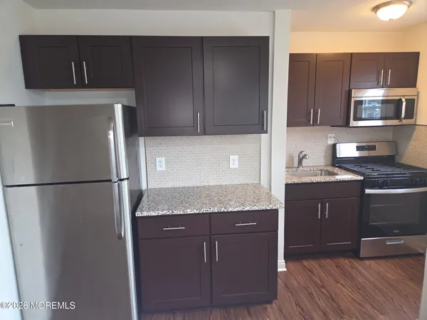 a kitchen with a refrigerator and a sink