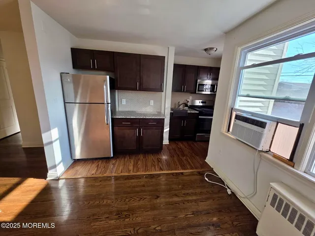 a kitchen with granite countertop a refrigerator and a stove