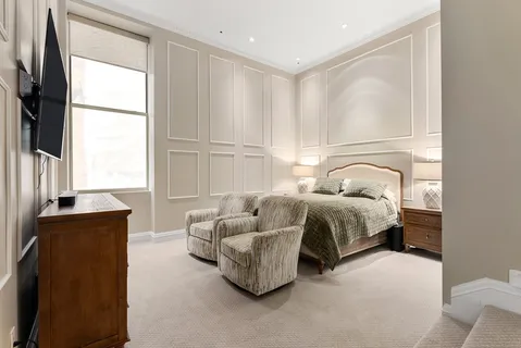 a bedroom with a bed and a couch
