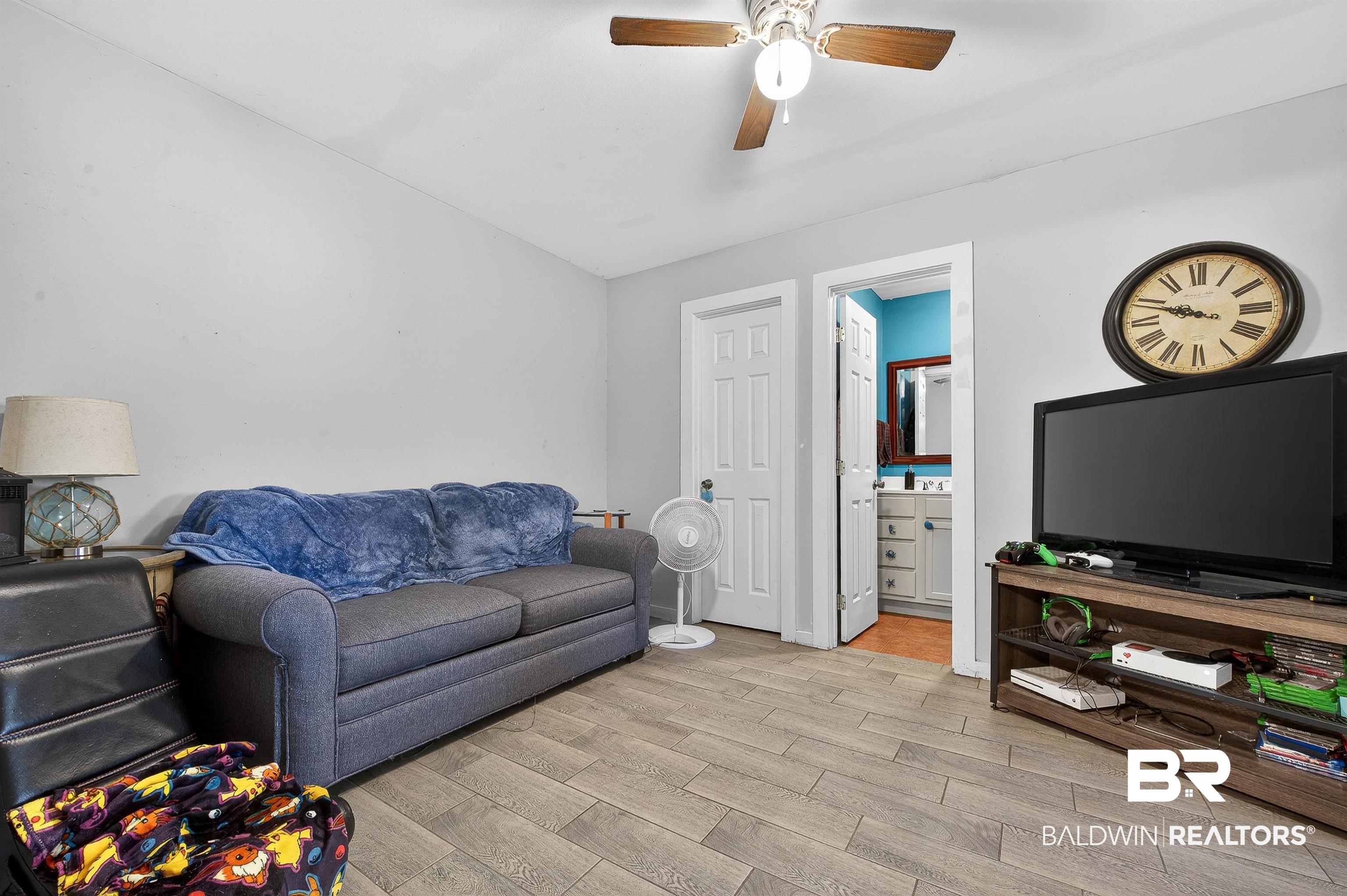 29635 Gardner Road Elberta, AL 36530 - Photo 46 of 66 Living area with wood finish floors and a ceiling fan