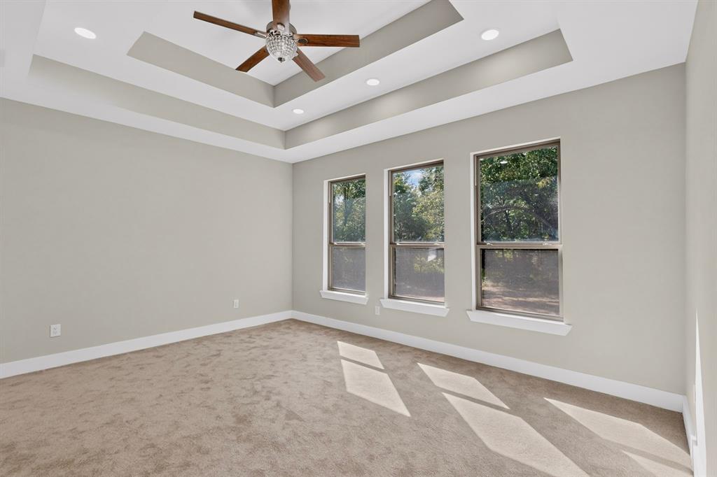 108 Winding Way Azle, TX 76020 - Photo 23 of 38 Tray ceiling with recessed lighting, ceiling fan, three windows, and neutral carpet