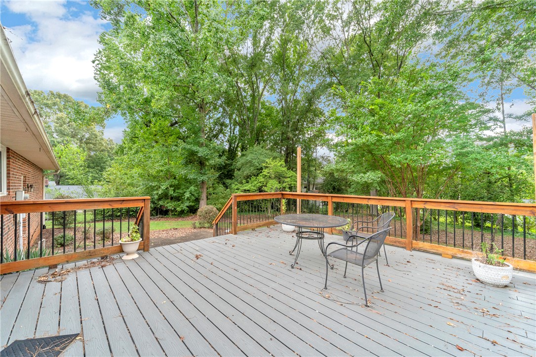 103 Colleton Court Clemson, SC 29631 - Photo 35 of 49 Mature trees frame the view from this spacious wooden deck with integrated safety railings.