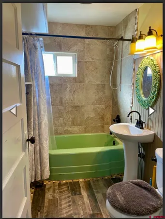 a bathroom with a sink a toilet and a bathtub