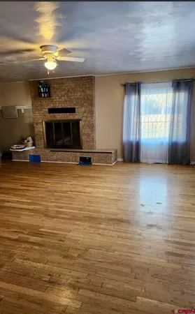 a view of empty room with a fireplace