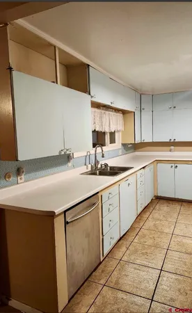 a kitchen with a sink cabinets and window