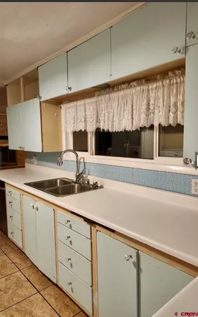 a kitchen with a sink and cabinets