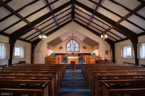 a view of a room with lots of wooden furniture