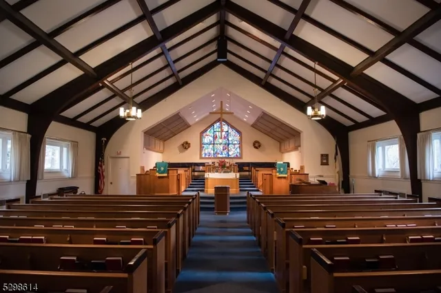 a view of a room with lots of wooden furniture