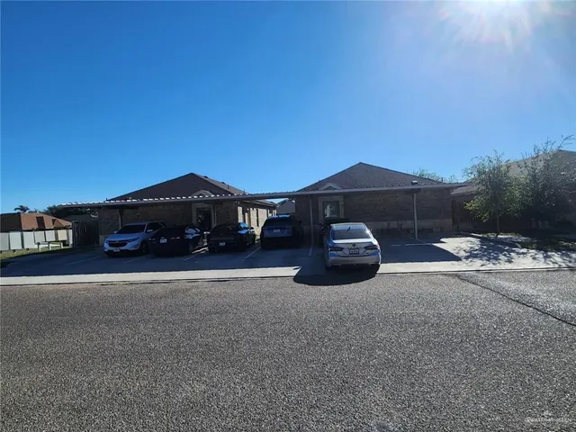 a front view of a house with a yard and parking space