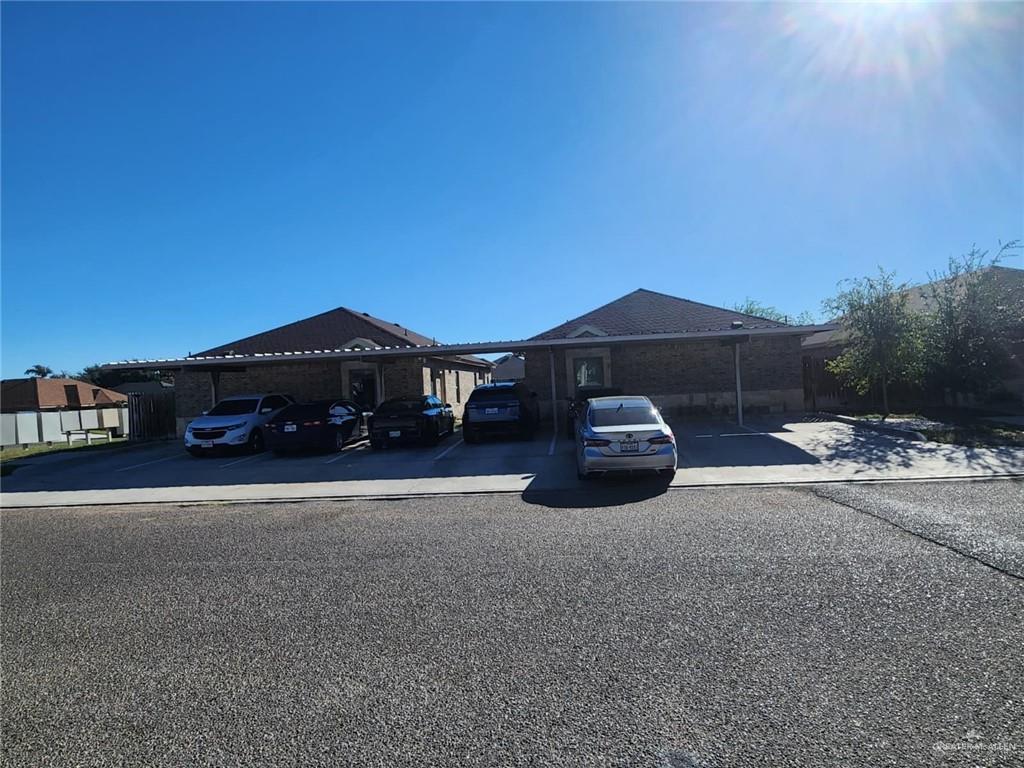 a front view of a house with a yard and parking space