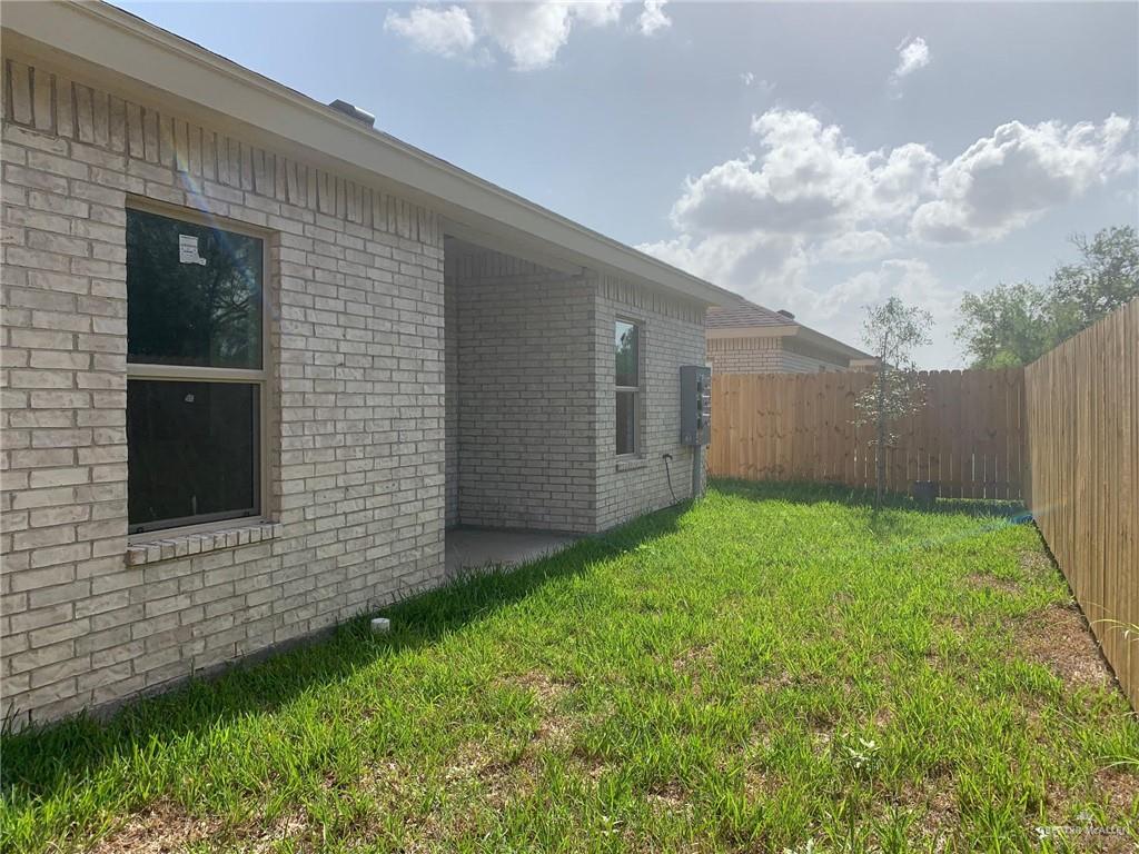 810 South Michigan Street, Unit 2 Alton, TX 78573 - Photo 14 of 14 a view of backyard with potted plants and wooden fence