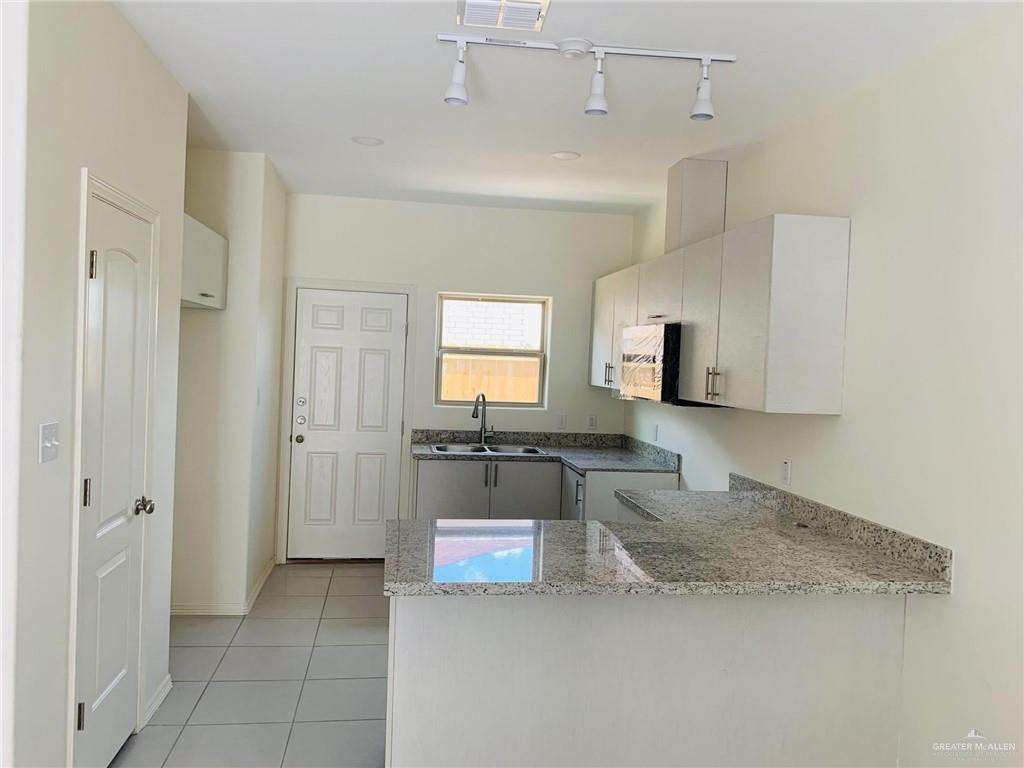 810 South Michigan Street, Unit 2 Alton, TX 78573 - Photo 4 of 14 a large kitchen with a stove a refrigerator and a sink