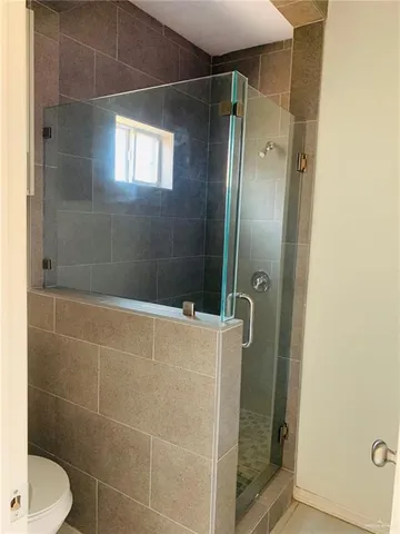 a bathroom with a shower and toilet
