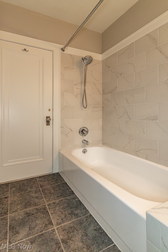 1345 Plainfield Road Cleveland, OH 44121 - Photo 15 of 33 1st floor Bathroom with tiled shower / bath combo and tile floors