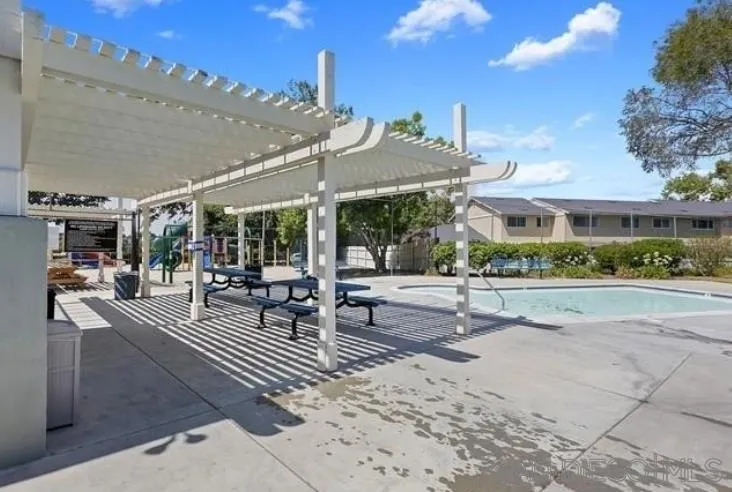 242 Village Green Road Encinitas, CA 92024 - Photo 2 of 16 a view of a patio with a table and chairs