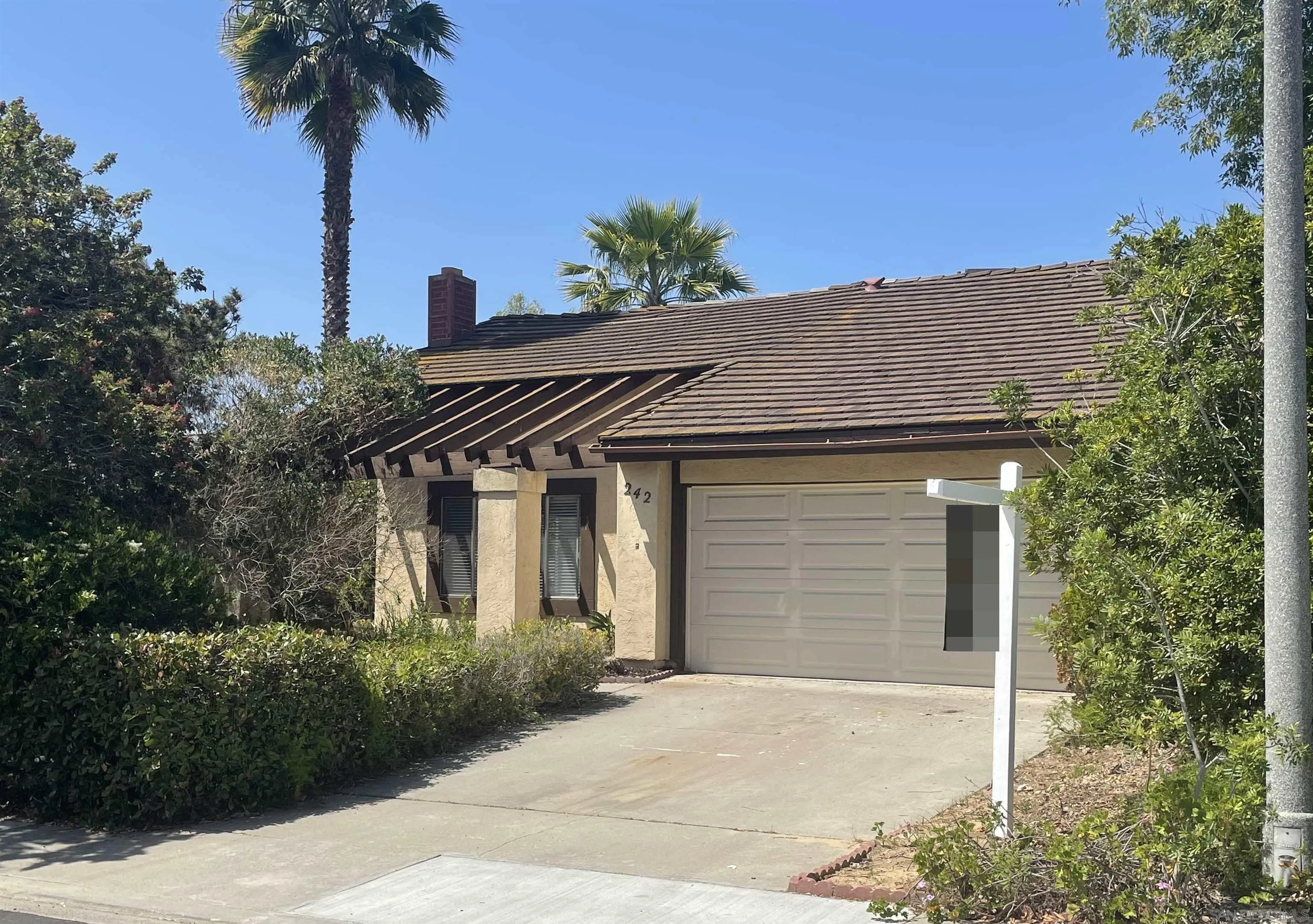 242 Village Green Road Encinitas, CA 92024 - Photo 3 of 16 a house that has a tree in front of the house