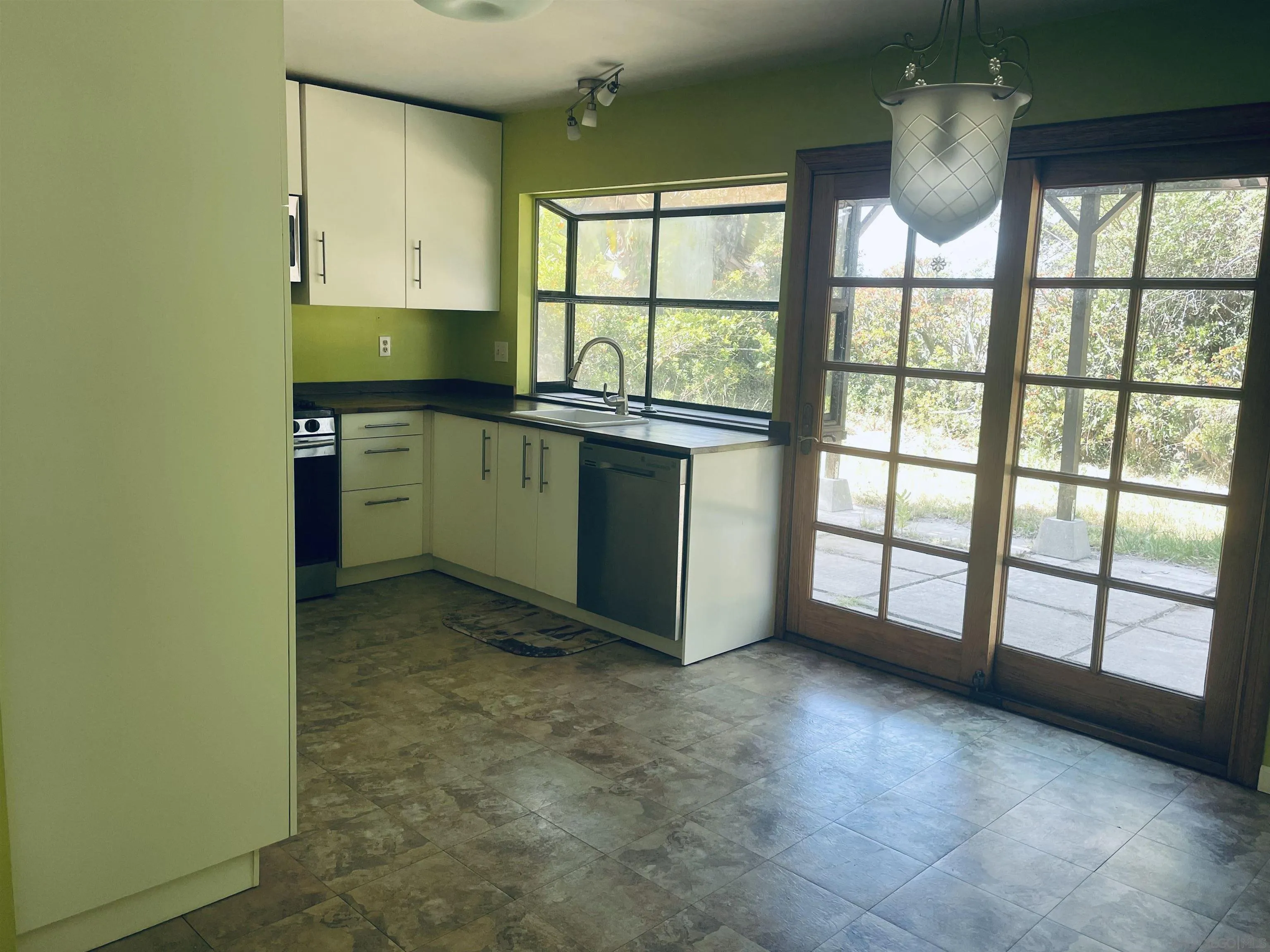 242 Village Green Road Encinitas, CA 92024 - Photo 9 of 16 a kitchen with window and cabinets
