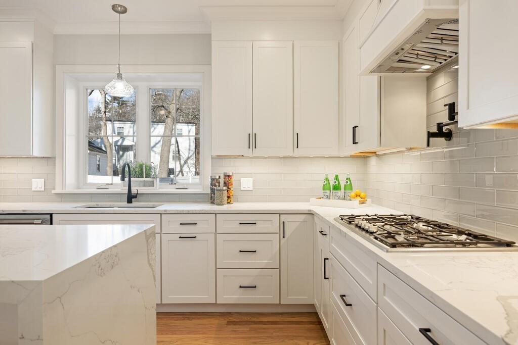 40 Bridge Street Lexington, MA 02421 - Photo 16 of 42 a kitchen with white cabinets and appliances