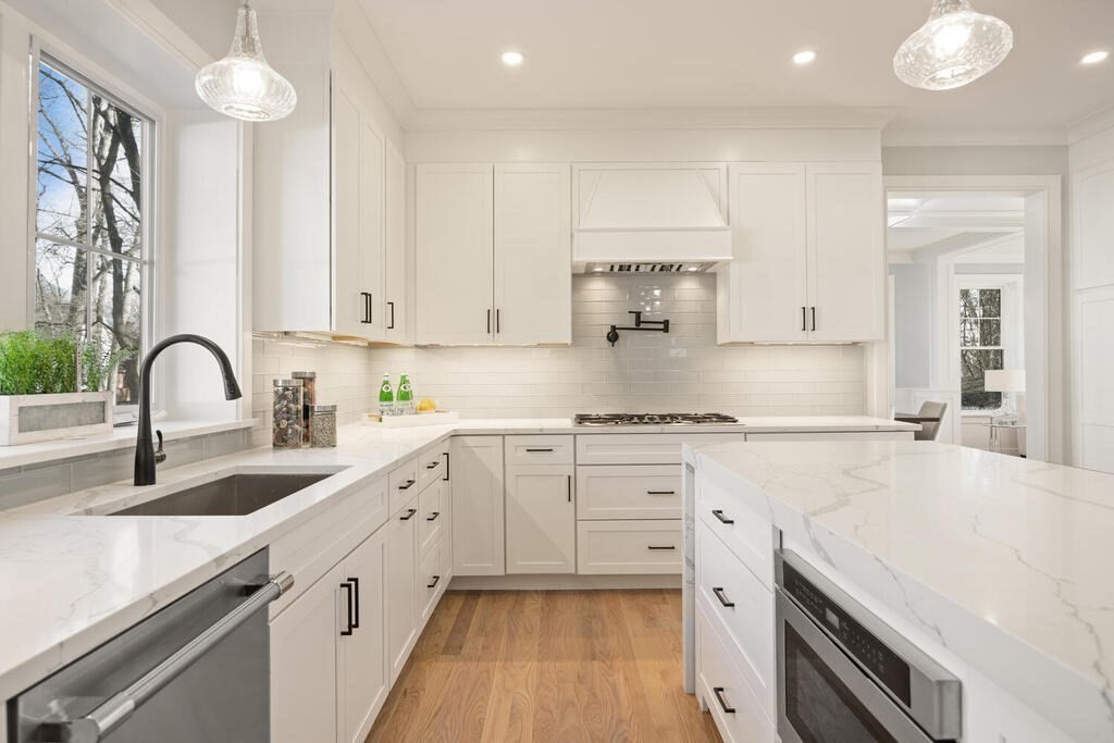 40 Bridge Street Lexington, MA 02421 - Photo 18 of 42 a kitchen with granite countertop white cabinets and white appliances