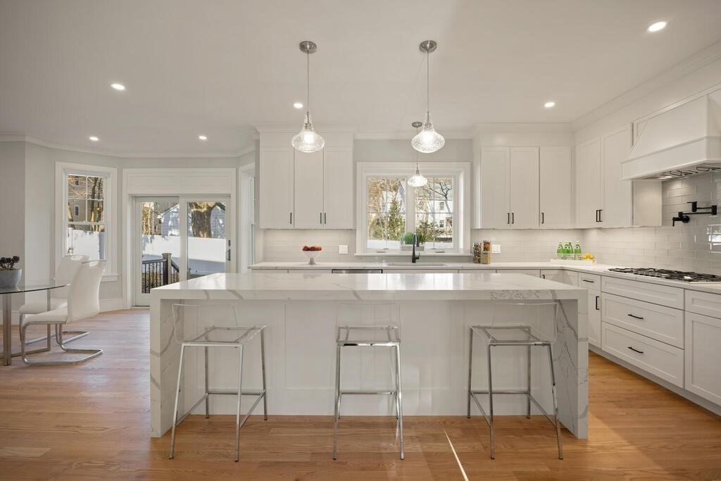 40 Bridge Street Lexington, MA 02421 - Photo 21 of 42 a large white kitchen with lots of counter space wooden floor and appliances
