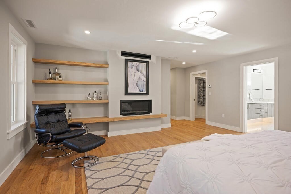 40 Bridge Street Lexington, MA 02421 - Photo 25 of 42 a bedroom with furniture and a fireplace
