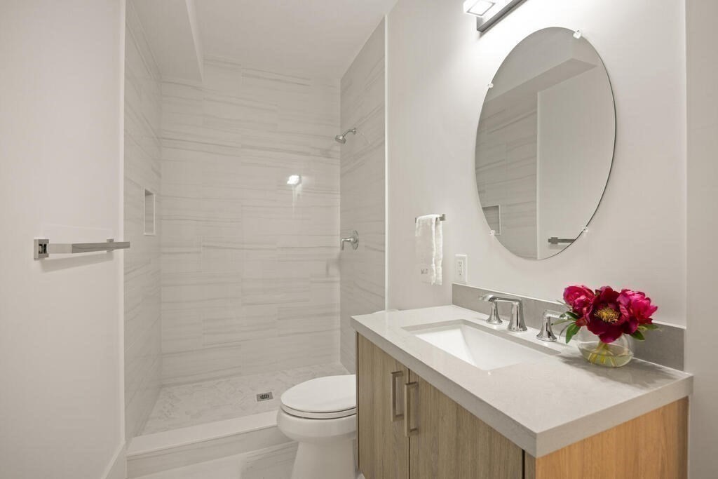 40 Bridge Street Lexington, MA 02421 - Photo 30 of 42 a bathroom with a sink and a mirror