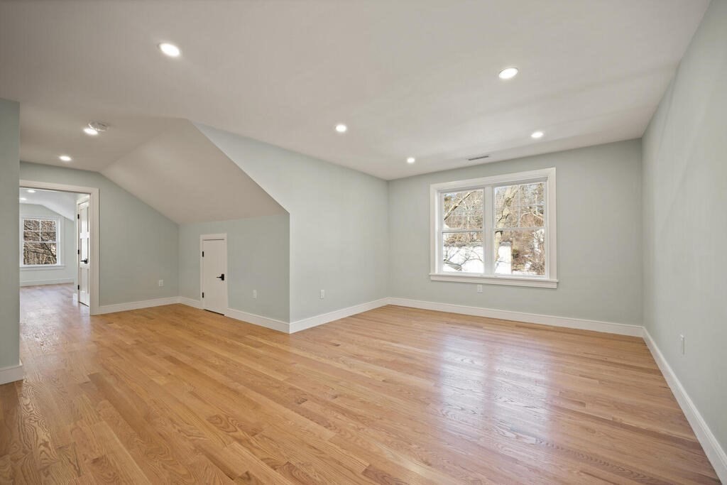 40 Bridge Street Lexington, MA 02421 - Photo 34 of 42 a view of an empty room with wooden floor and a window