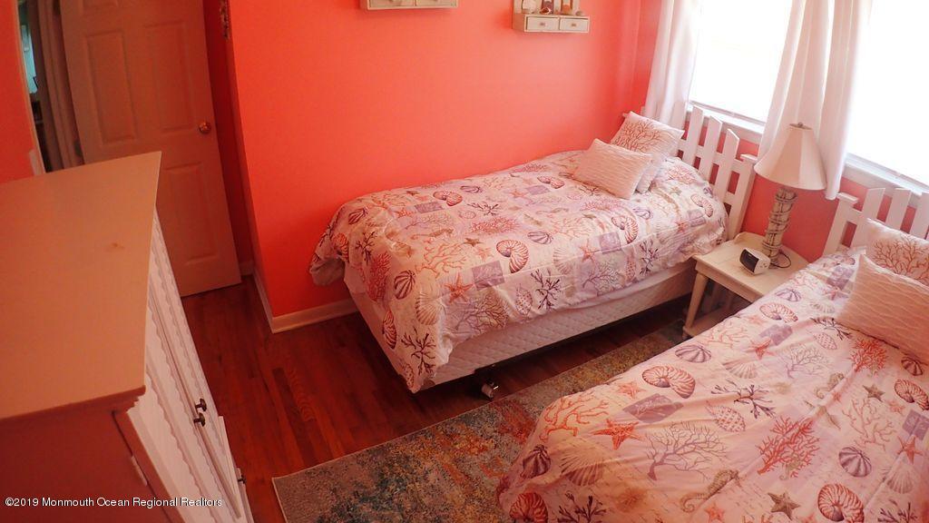 20 McClintock Street Ocean Grove, NJ 07756 - Photo 11 of 19 a bed sitting in a bedroom next to a window
